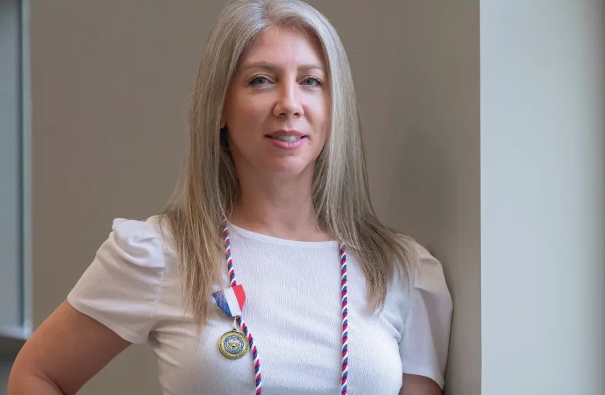 A woman wearing a medallion.